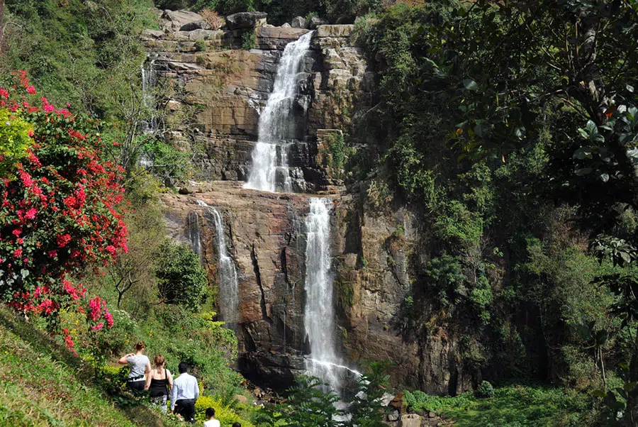 Tea-covered hills and a waterfall near Nuwara Eliya
