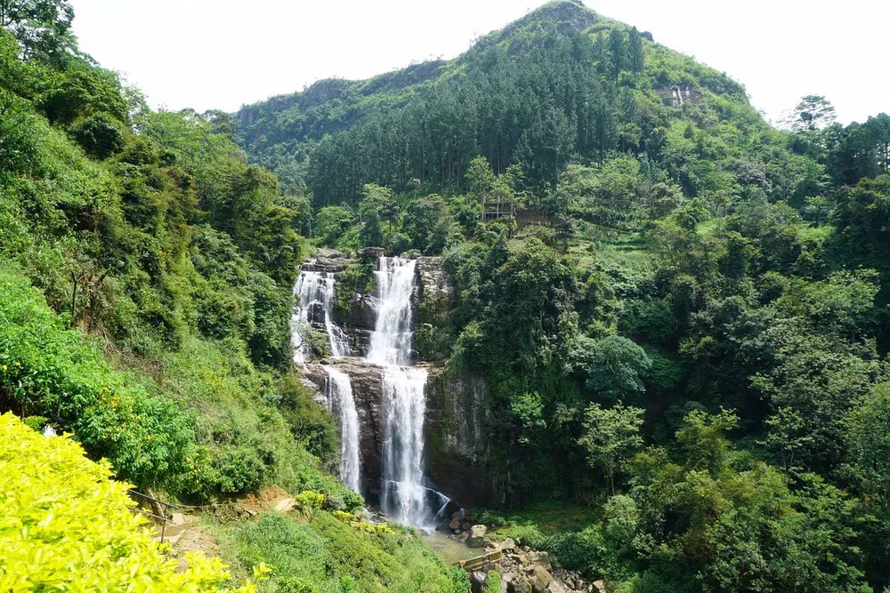 Tea-covered hills and a waterfall near Nuwara Eliya
