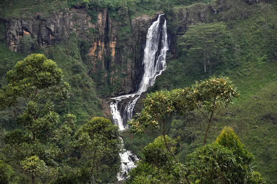 Tea-covered hills and a waterfall near Nuwara Eliya